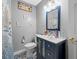 Bathroom featuring a blue vanity, decorative tile floor and framed mirror at 538 Bamboo Ln, Clearwater, FL 33764
