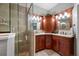 Updated bathroom featuring double sinks, granite counters, and a glass shower enclosure at 538 Bamboo Ln, Clearwater, FL 33764
