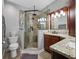 Bathroom featuring a glass-enclosed shower with decorative tile and granite countertops at 538 Bamboo Ln, Clearwater, FL 33764