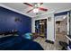 Bedroom with dark blue accent wall, closet and gray floor at 538 Bamboo Ln, Clearwater, FL 33764