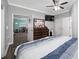 Bedroom with wood floors, ceiling fan, ensuite bathroom, and closet space at 538 Bamboo Ln, Clearwater, FL 33764