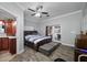 Cozy bedroom features wood floors, ceiling fan, ensuite bathroom, and access to the pool area at 538 Bamboo Ln, Clearwater, FL 33764