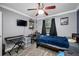 Cozy bedroom with a ceiling fan, keyboard, and a well-lit window at 538 Bamboo Ln, Clearwater, FL 33764