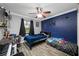Bedroom with beds, dark blue accent wall, and a desk at 538 Bamboo Ln, Clearwater, FL 33764