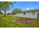 Side view of a home featuring a screened-in pool area at 538 Bamboo Ln, Clearwater, FL 33764