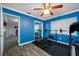Home gym with blue walls, weights and exercise equipment and view to another room at 538 Bamboo Ln, Clearwater, FL 33764
