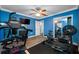 Home gym with blue walls, a treadmill, a punching bag and exercise equipment at 538 Bamboo Ln, Clearwater, FL 33764