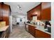 Cozy kitchen with dark wood cabinets, stainless steel appliances, and granite countertops overlooking living area at 538 Bamboo Ln, Clearwater, FL 33764