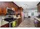 Modern kitchen with granite countertops, stainless steel appliances, and wood cabinets at 538 Bamboo Ln, Clearwater, FL 33764