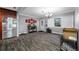 Large living room features an entry door, a stylish chandelier, and wood-look floors at 538 Bamboo Ln, Clearwater, FL 33764