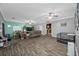 Open-concept living room with neutral tones and wood-look flooring at 538 Bamboo Ln, Clearwater, FL 33764