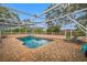 Relaxing screened-in pool with brick patio and comfortable lounge seating at 538 Bamboo Ln, Clearwater, FL 33764