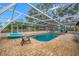 Enclosed pool with brick patio, chairs, and fun inflatable toys at 538 Bamboo Ln, Clearwater, FL 33764