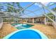 Backyard oasis featuring a screened-in pool, brick patio, and outdoor seating area at 538 Bamboo Ln, Clearwater, FL 33764