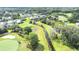 Scenic aerial view of the golf course with lush fairways, water features, and beautiful surrounding landscaping and luxury homes at 5931 Cherry Oak Dr, Valrico, FL 33596