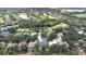 Aerial view of a neighborhood with lush landscaping, a lake, and a golf course nearby at 5931 Cherry Oak Dr, Valrico, FL 33596