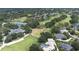 Beautiful aerial view of a golf course, tennis courts, clubhouse and luxury homes surrounded by mature trees and landscaping at 5931 Cherry Oak Dr, Valrico, FL 33596