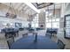 Well-lit ballroom featuring a stone fireplace, large windows, and seating arrangements at 5931 Cherry Oak Dr, Valrico, FL 33596
