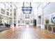 Spacious ballroom featuring high ceilings, hardwood floors, and elegant lighting fixtures at 5931 Cherry Oak Dr, Valrico, FL 33596