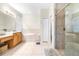Bright bathroom features dual sinks, a soaking tub, and a glass-enclosed shower at 5931 Cherry Oak Dr, Valrico, FL 33596