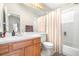 Bright bathroom features a single vanity, updated fixtures, and a shower-tub combo with a shower curtain at 5931 Cherry Oak Dr, Valrico, FL 33596
