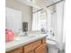 Functional bathroom with a wooden vanity, large mirror and shower/tub combination at 5931 Cherry Oak Dr, Valrico, FL 33596