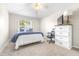 Comfortable bedroom features neutral colors, cozy carpet, and a window that provides ample natural light at 5931 Cherry Oak Dr, Valrico, FL 33596