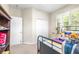 Cozy bedroom with a window offering natural light and carpeted floors at 5931 Cherry Oak Dr, Valrico, FL 33596