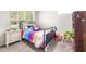 Bright bedroom featuring a large window and a comfortable bed with colorful bedding at 5931 Cherry Oak Dr, Valrico, FL 33596