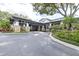 Elegant clubhouse entrance featuring stone columns, porte-cochere, and landscaped grounds at 5931 Cherry Oak Dr, Valrico, FL 33596