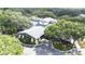 Aerial view of the clubhouse featuring beautiful architecture, lush landscaping, and ample parking, surrounded by mature trees at 5931 Cherry Oak Dr, Valrico, FL 33596
