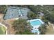 Aerial view of community amenities, including a pool, tennis courts, and mature trees at 5931 Cherry Oak Dr, Valrico, FL 33596