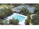 Aerial view of a community pool, tennis courts, and clubhouse surrounded by trees at 5931 Cherry Oak Dr, Valrico, FL 33596