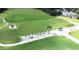 Aerial view of a well-maintained driving range with lush green grass and multiple tee boxes, surrounded by mature trees at 5931 Cherry Oak Dr, Valrico, FL 33596