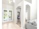 Bright foyer with neutral tile flooring, arched doorways, and natural light from the glass double doors at 5931 Cherry Oak Dr, Valrico, FL 33596