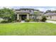 Beautiful home boasts lush green lawn, mature trees, and manicured landscaping for great curb appeal at 5931 Cherry Oak Dr, Valrico, FL 33596