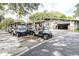 Several golf carts are parked near a building, likely part of a golf community at 5931 Cherry Oak Dr, Valrico, FL 33596