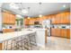 Bright kitchen featuring an island with seating, modern appliances, and lots of cabinets for storage at 5931 Cherry Oak Dr, Valrico, FL 33596