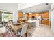 Island kitchen in a great room with a dining area, large windows, and access to the lanai at 5931 Cherry Oak Dr, Valrico, FL 33596