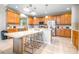 Bright kitchen featuring an island with seating, modern appliances, and lots of cabinets for storage at 5931 Cherry Oak Dr, Valrico, FL 33596