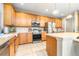 Well-equipped kitchen features stainless steel appliances, ample cabinetry, and light countertops at 5931 Cherry Oak Dr, Valrico, FL 33596