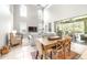 Bright living room with high ceilings, tall windows, a dining area, and sliding glass doors at 5931 Cherry Oak Dr, Valrico, FL 33596