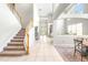 Bright living room with high ceilings, a staircase, and a view into another room at 5931 Cherry Oak Dr, Valrico, FL 33596