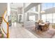 Bright living room with a dining area, high ceilings, and staircase with wood and white banister at 5931 Cherry Oak Dr, Valrico, FL 33596