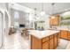 Bright living room with island kitchen, dining area, and large windows providing ample natural light at 5931 Cherry Oak Dr, Valrico, FL 33596