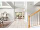 Bright living room with staircase and view into another room and sliding doors to the lanai at 5931 Cherry Oak Dr, Valrico, FL 33596