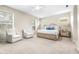 Spacious main bedroom with plush carpet, bright windows, ceiling fan, and sitting area at 5931 Cherry Oak Dr, Valrico, FL 33596