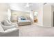 Bright main bedroom with plush carpet, and ensuite bath through arched doorway at 5931 Cherry Oak Dr, Valrico, FL 33596