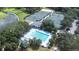 Aerial view of community pools, featuring a large lap pool and a smaller pool, surrounded by lush landscaping and mature trees at 5931 Cherry Oak Dr, Valrico, FL 33596