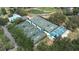 Aerial view of community tennis courts with multiple well-maintained green courts and blue awnings, surrounded by mature landscaping at 5931 Cherry Oak Dr, Valrico, FL 33596
